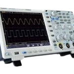 Oscilloscope showing a waveform on its screen with front control knobs and buttons visible.